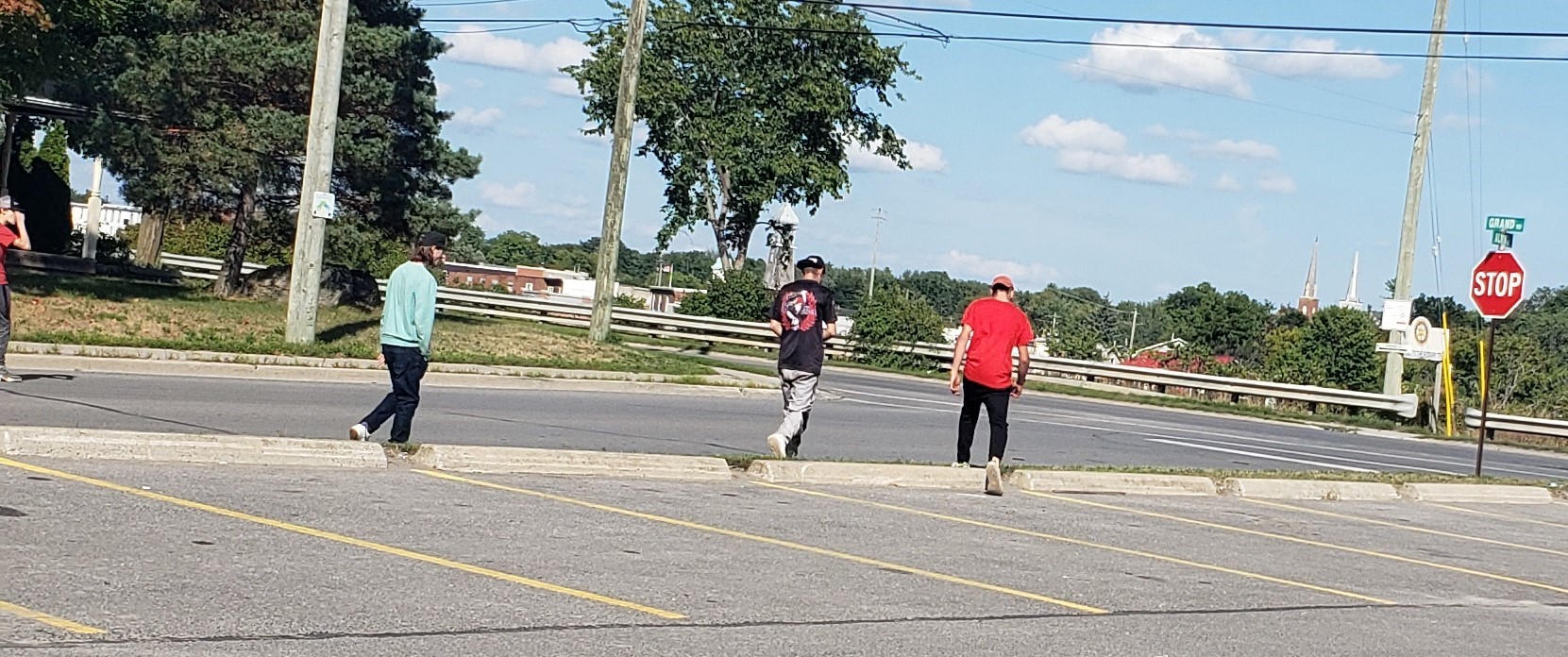 People walking towards a stop sign